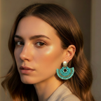 Woman wearing turquoise beaded earrings with a neutral background