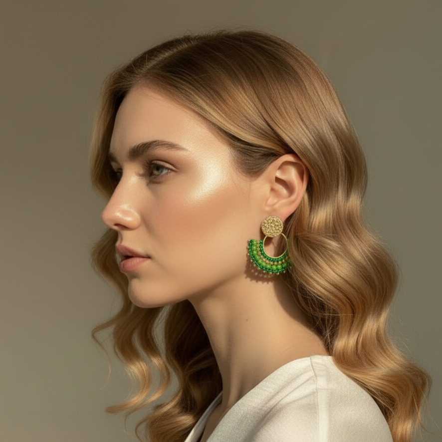 Woman wearing green earrings with a neutral background