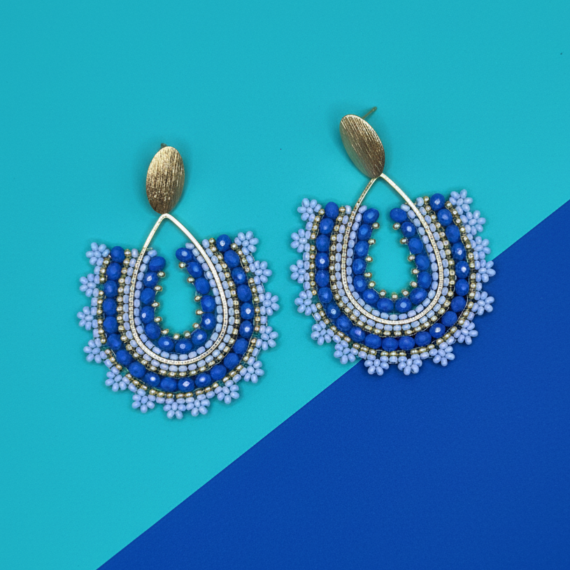 Beaded earrings on a blue and teal background