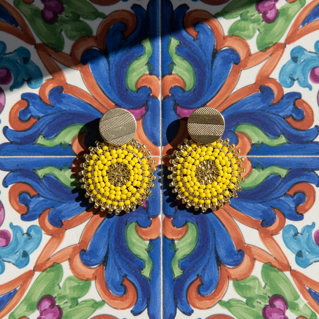 Yellow Manila earrings on a colorful tile background